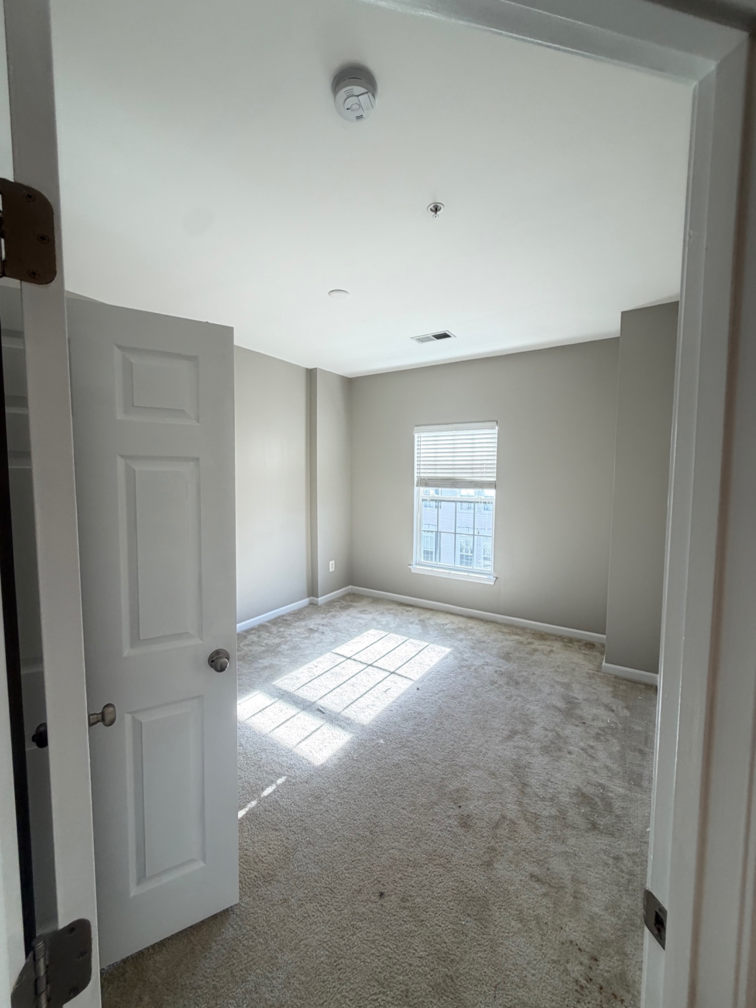 Finished interior room with fresh paint and carpeting